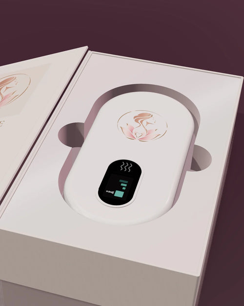 Le coffret Lumae ouvert comme un livre, la ceinture chauffante blanche dans son écrin nacré.